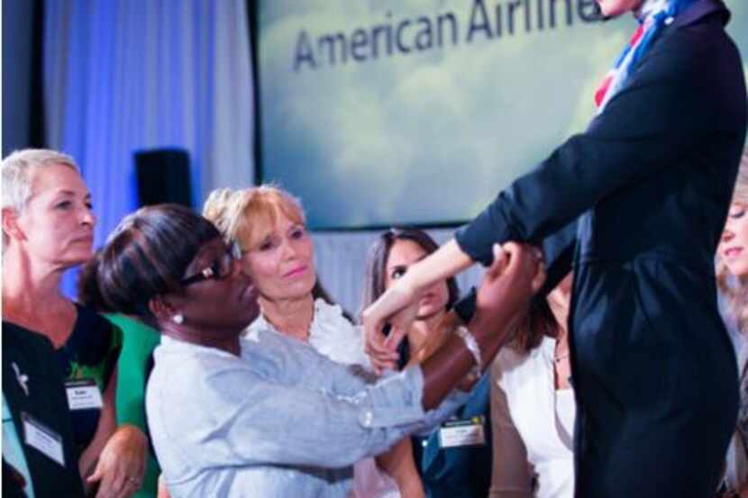  American Airlines employees check out one of the prototype uniforms. (AA photo)