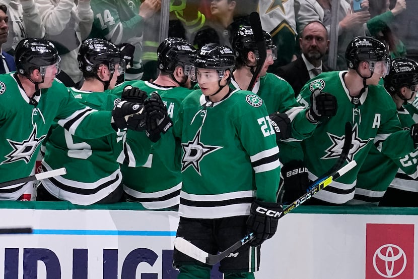 Dallas Stars' Jason Robertson celebrates with the bench after scoring in the second period...