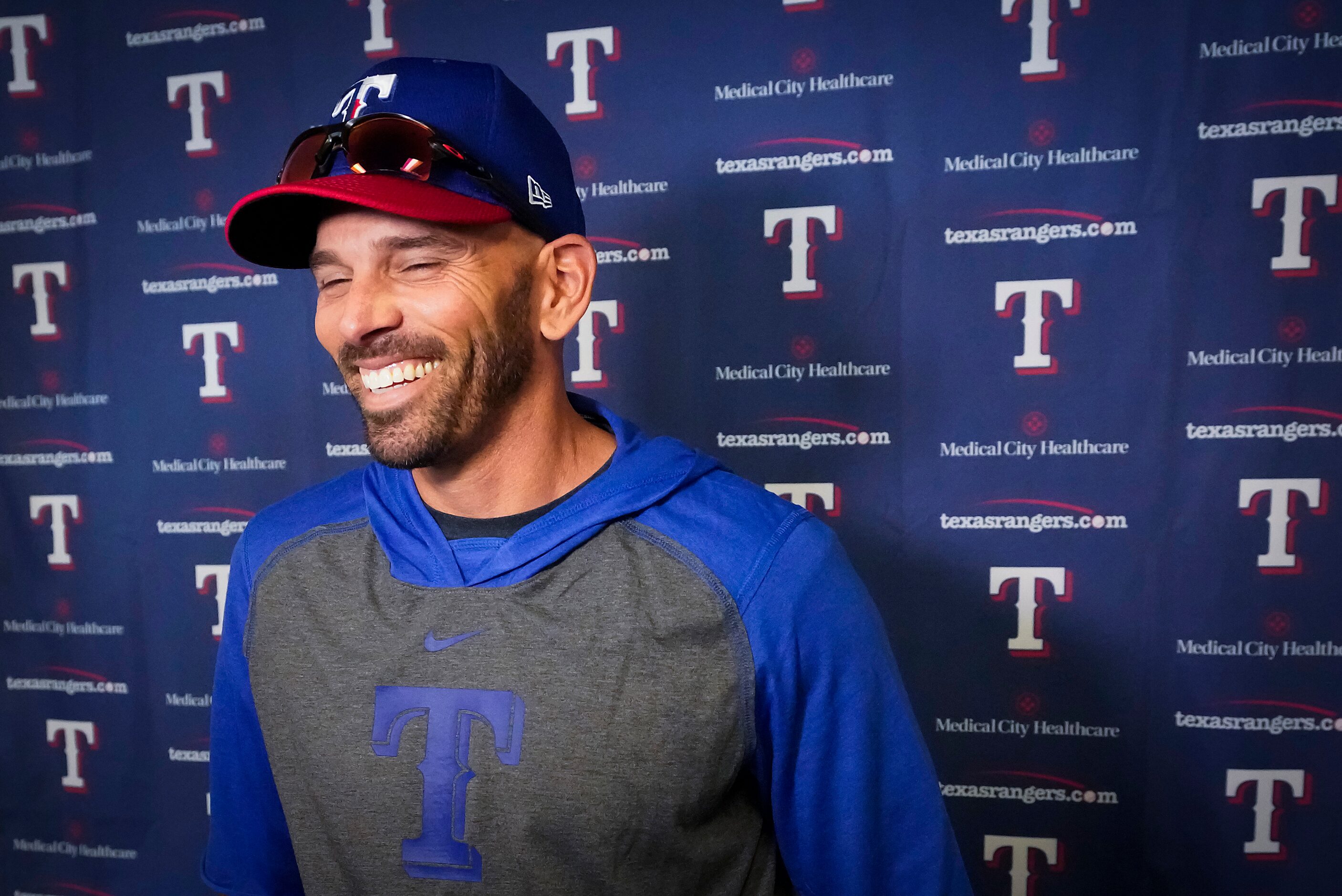 Texas Rangers manager Chris Woodward smiles while addressing the media before the first...