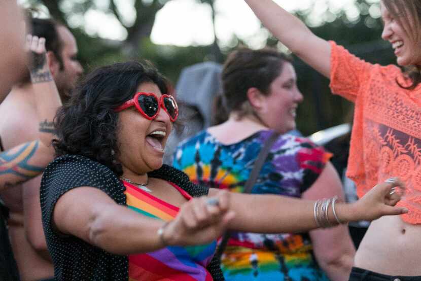 Ish Kundawala dances at a party to show support of the LGBTQ community gathered in front of...