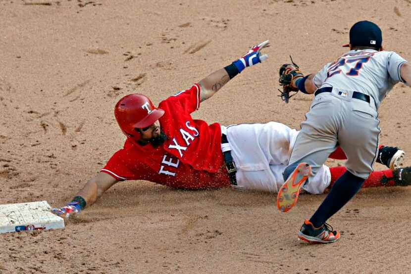 Rangers second baseman Rougned Odor (12) slides by Houston Astros second baseman Jose Altuve...