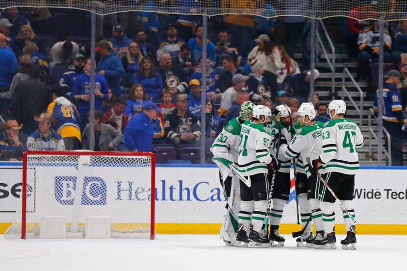 Dallas Stars' Jamie Benn (14) is congratulated by his teammates after recording a hat trick...