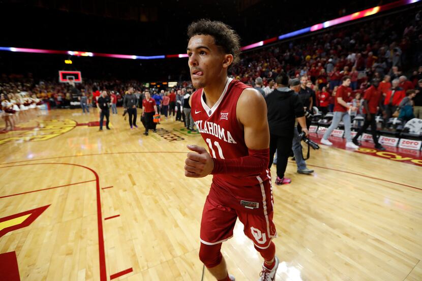 Oklahoma guard Trae Young runs off the court at the end of an NCAA college basketball game...