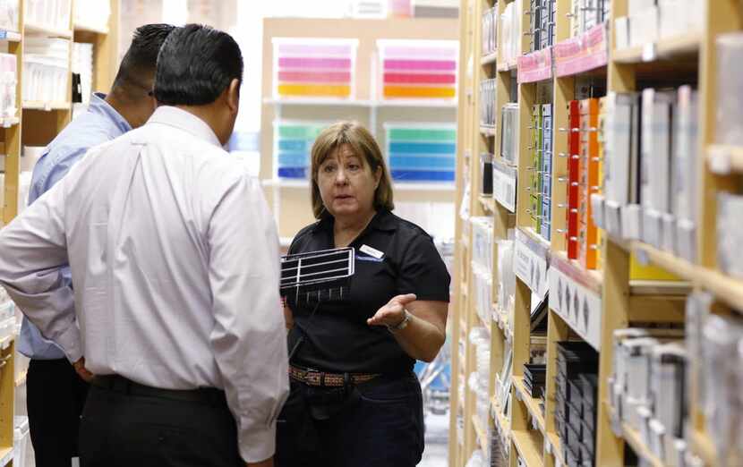 Marsha Meyers, 66, helps customers at the Container Store in Dallas. "I like to help people...