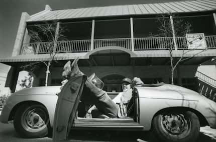 Tom Garrison, owner of the Stoneleigh P bar in Dallas, relaxes in his Porsche in 1988. At...