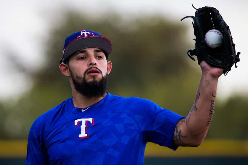 Texas Rangers second baseman Rougned Odor (12) catches a ball during a spring training...