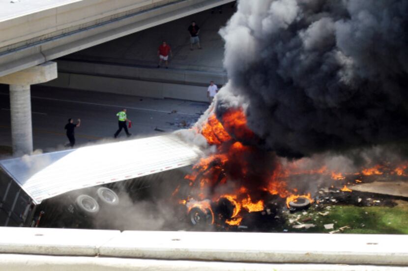 Smoke could be seen for miles Saturday afternoon after an 18-wheeler crashed onto State...