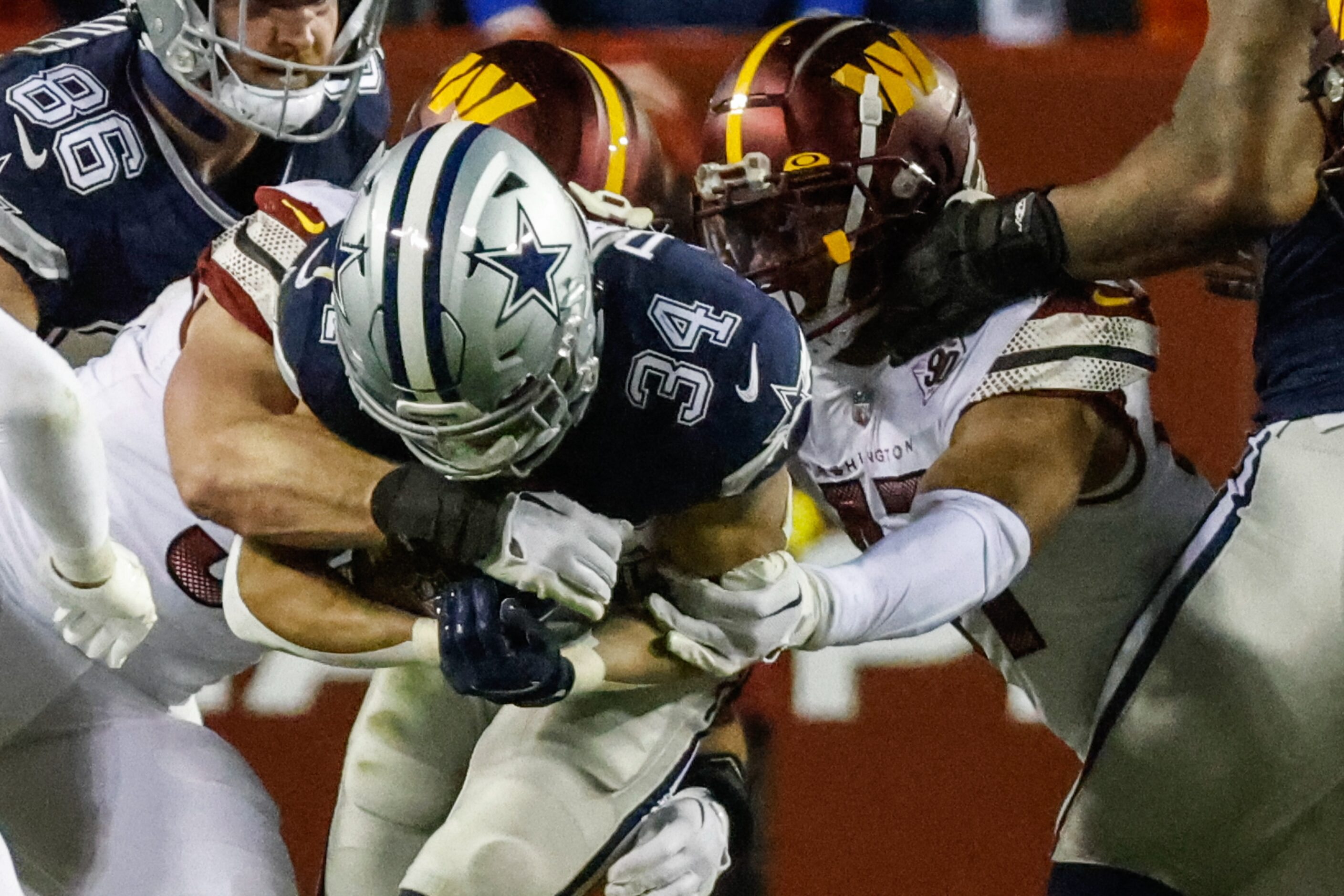 Dallas Cowboys running back Malik Davis (34) gets tackled during the second half against...