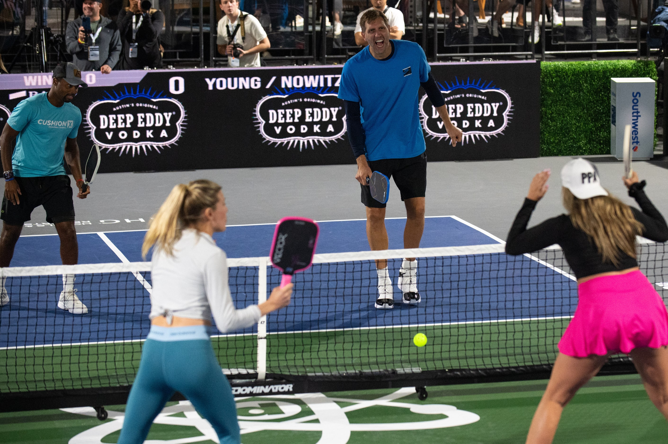 Pro Pickleball player Donald Young, top-far-left, watches as former Dallas Mavericks center...