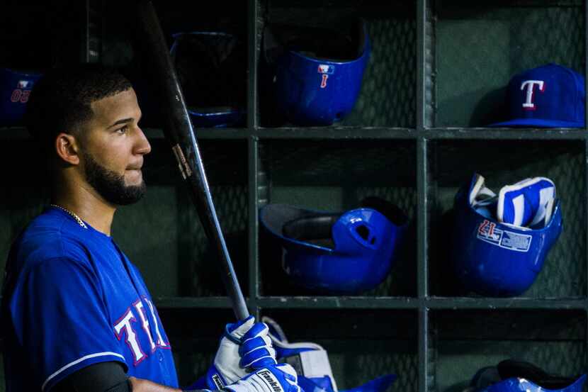 Texas Rangers left fielder Nomar Mazara (30) warms up in the dugout during the fifth inning...