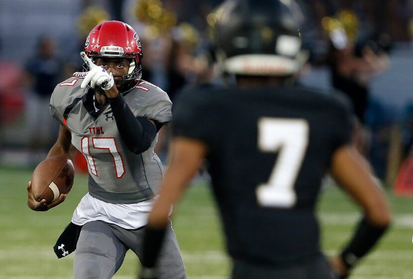 TXHSFB Cedar Hill junior quarterback Shayne Lawrence (17) looks for room against as...