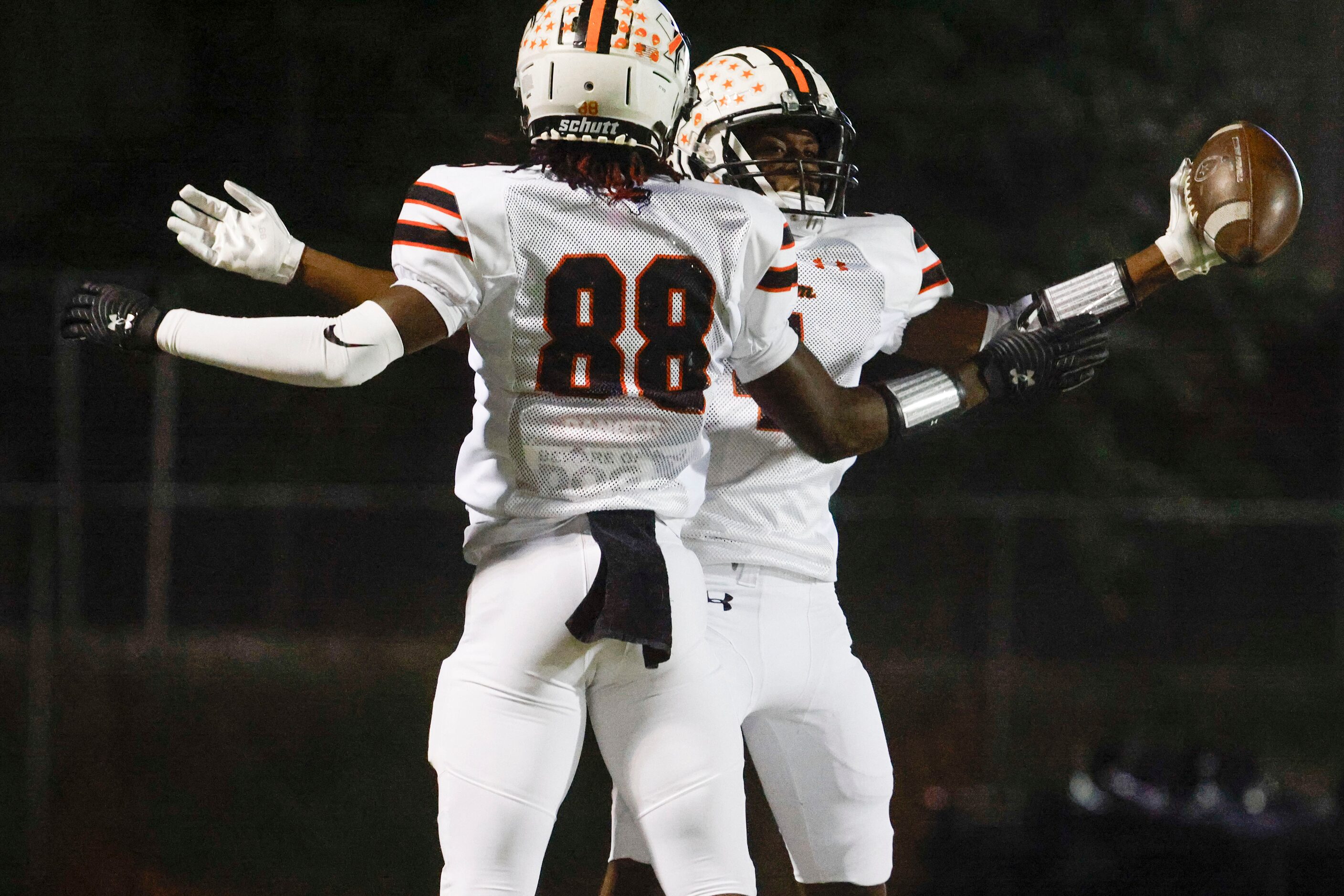 Haltom high’s DQ barnes (left) and Ishmeal Jalloh celebrate a touchdown against Keller high...