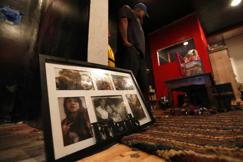 
Jacob Ortega walks by family pictures placed on the floor inside a shed where his three...