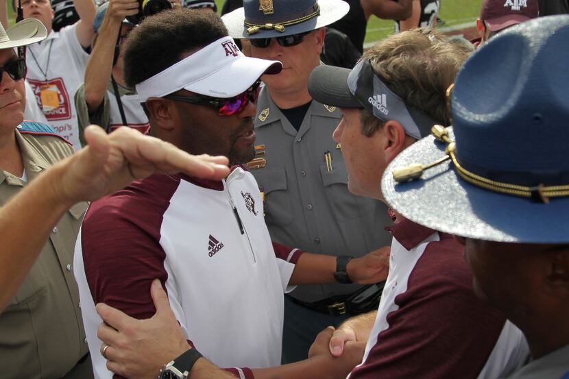 Mississippi State head coach Dan Mullen, center right, shakes hands with Texas A&M head...