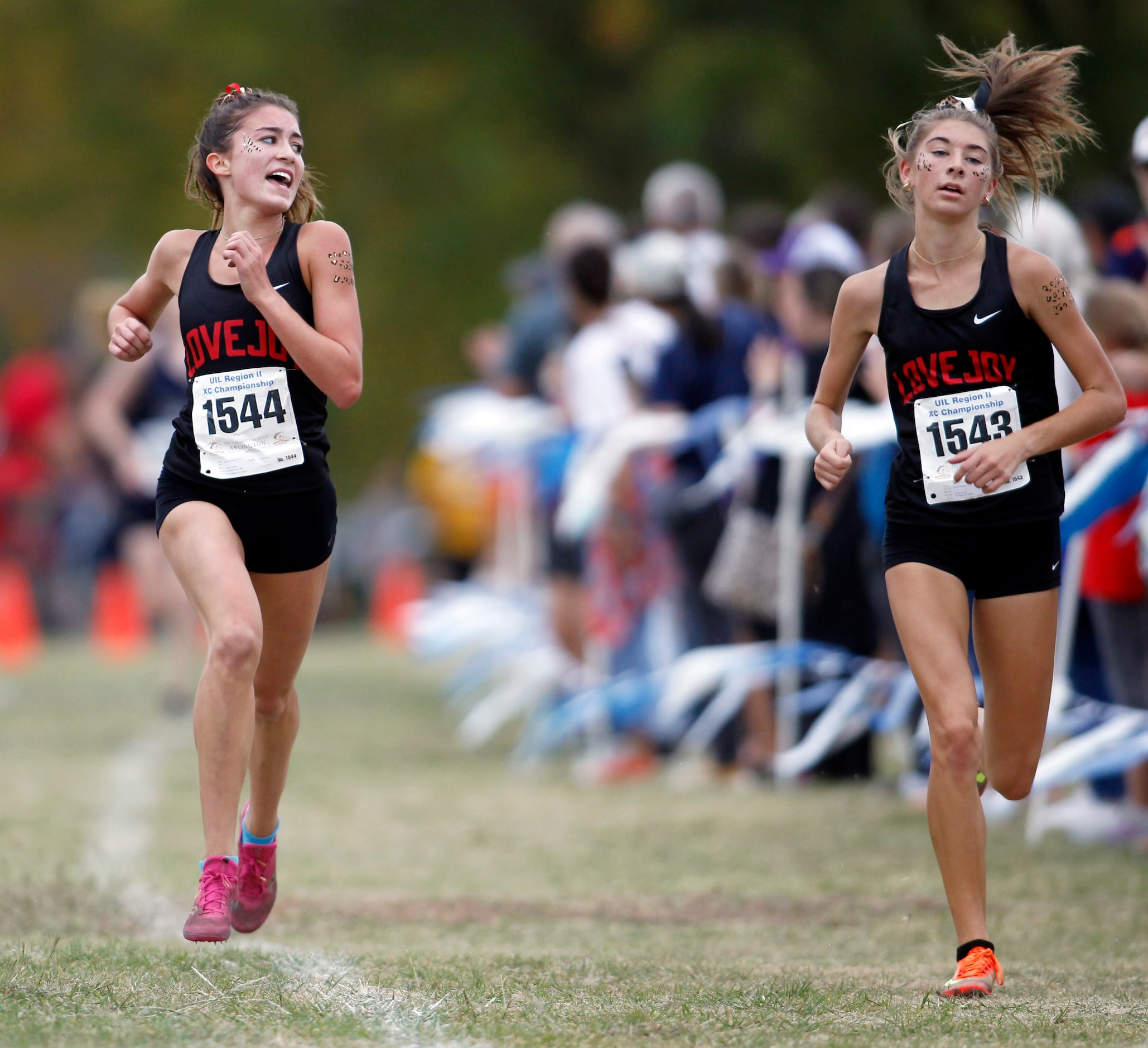 Lucas Lovejoy sophomore Bridget Bernal (1544), left, glances toward senior teammate Peyton...