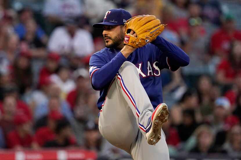 Texas Rangers starting pitcher Martin Perez throws to the plate during the fourth inning of...