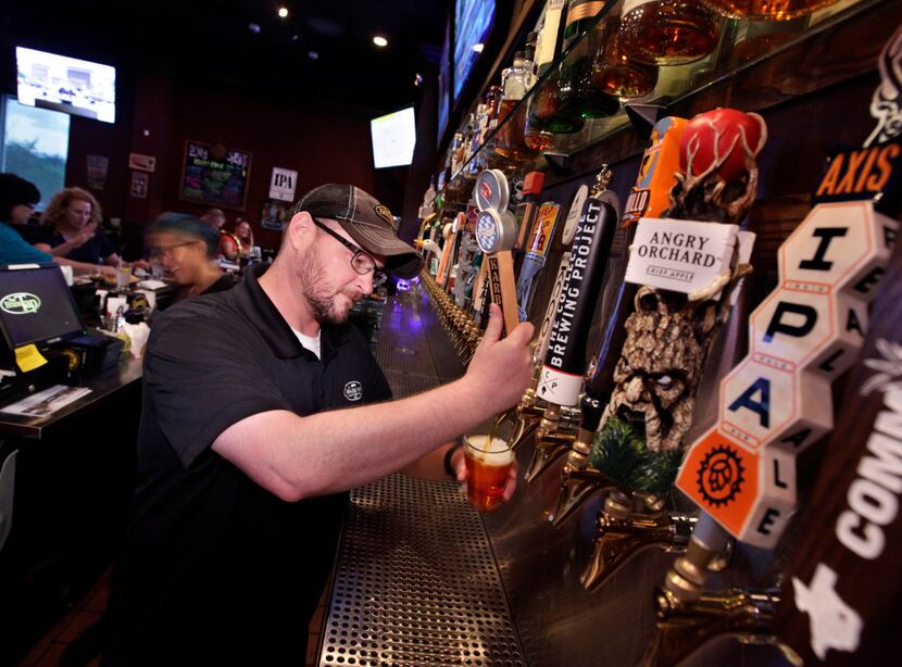 Stephen Walden pours a beer at The Brass Tap in Allen.