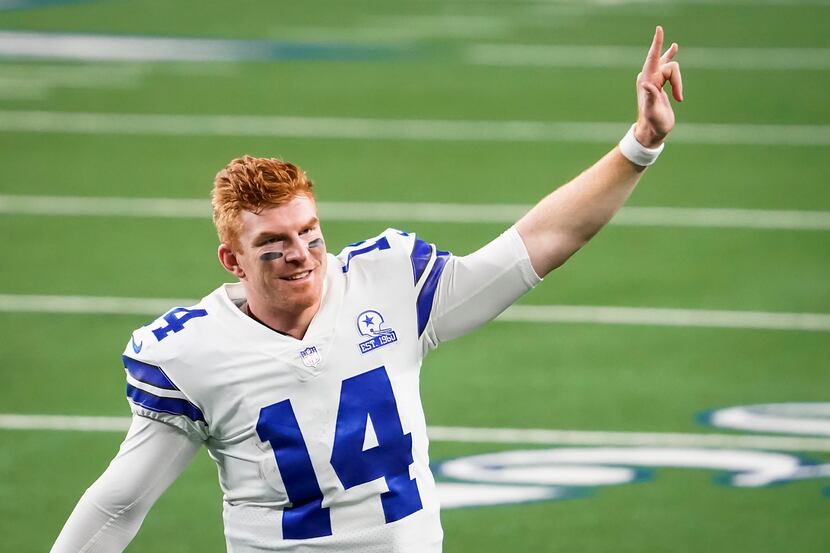 Dallas Cowboys quarterback Andy Dalton celebrates as he leaves the field after a win over...