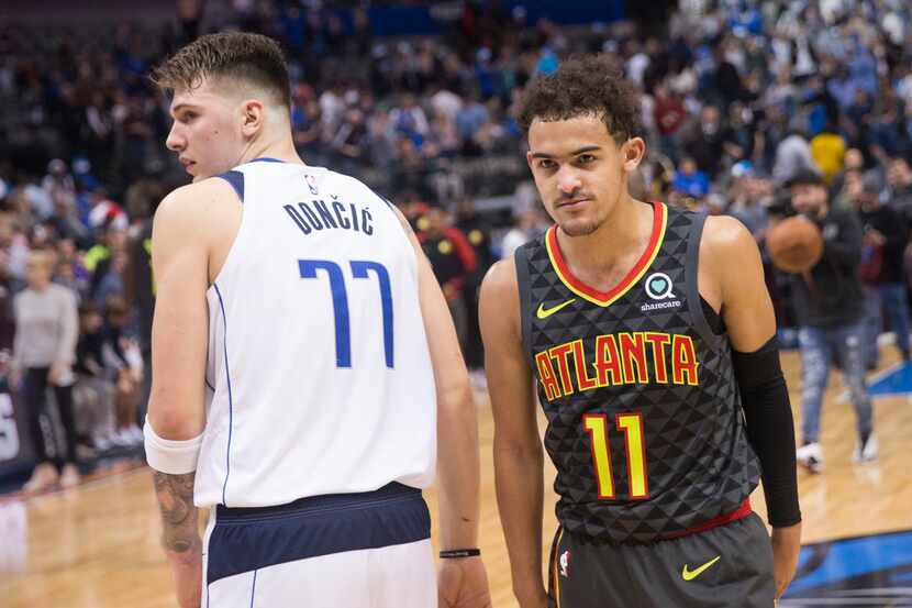 Dallas Mavericks forward Luka Doncic (77) and Atlanta Hawks guard Trae Young (11) after an...