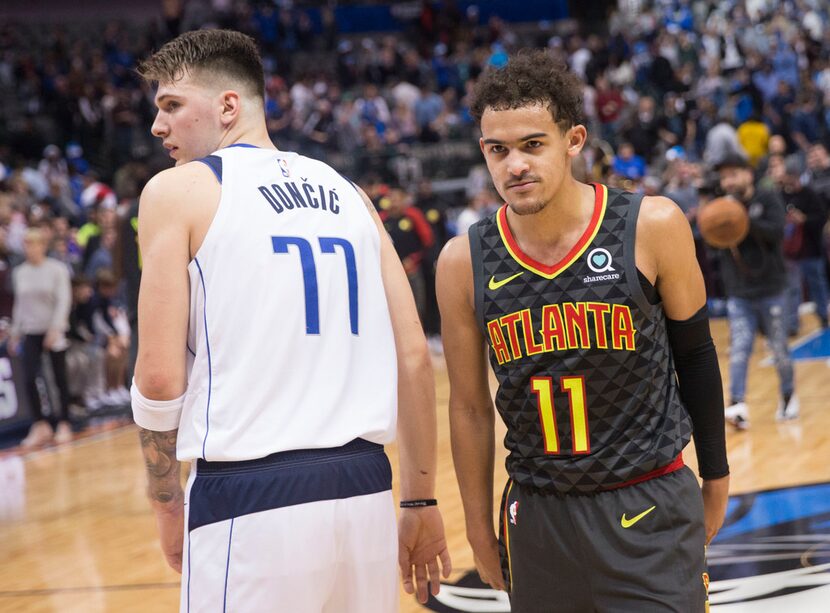 Dallas Mavericks forward Luka Doncic (77) and Atlanta Hawks guard Trae Young (11) after an...