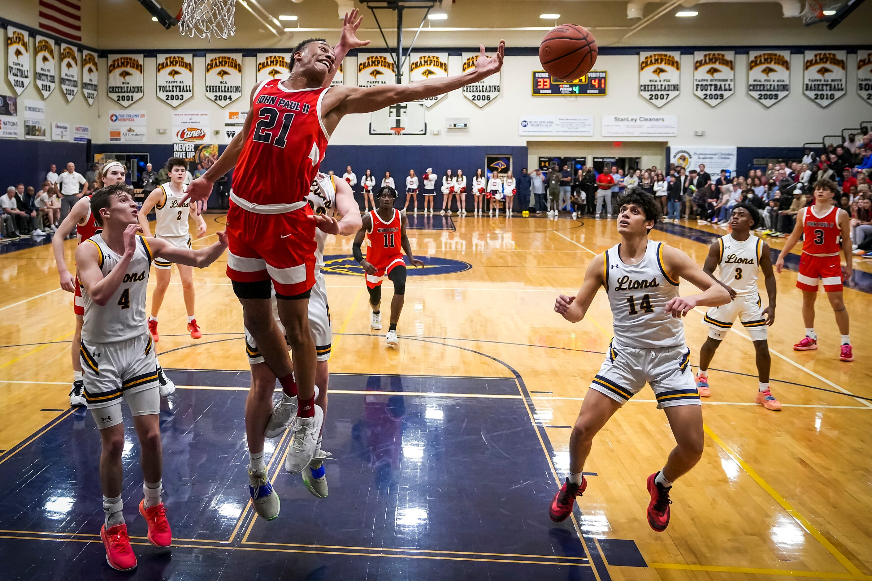 John Paul II's Gabe Warren (21) reaches for a rebound against Prestonwood Christian's Joshua...