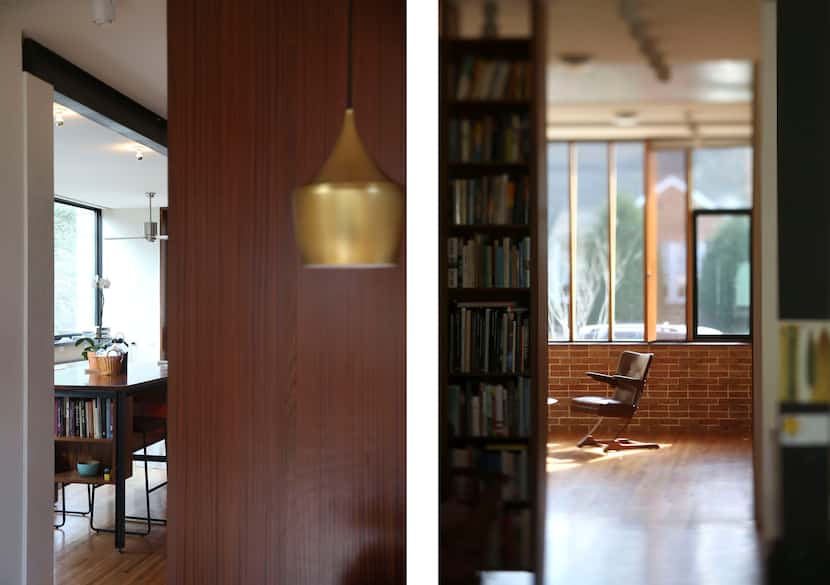 LEFT: A suspended light hangs over the dining table in an area backed by a smooth,...