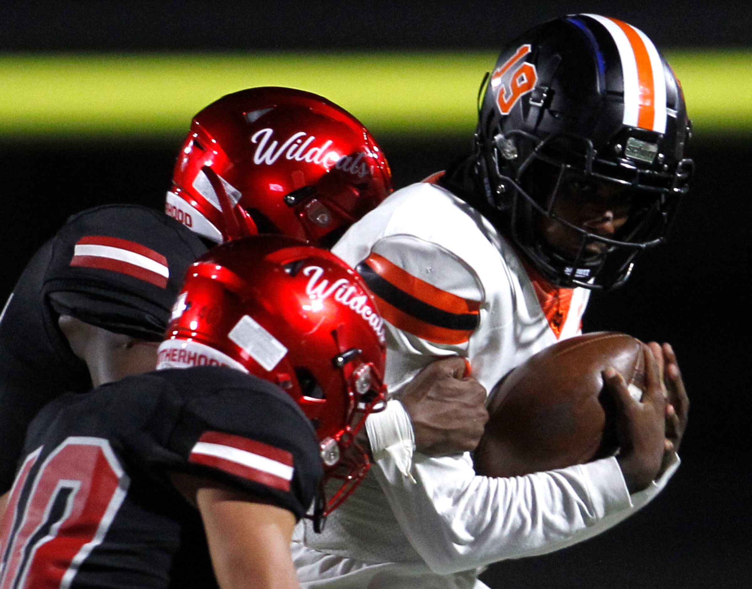 Lancaster quarterback Glenn Rice (3) rushes for a first down before being stopped by a pair...