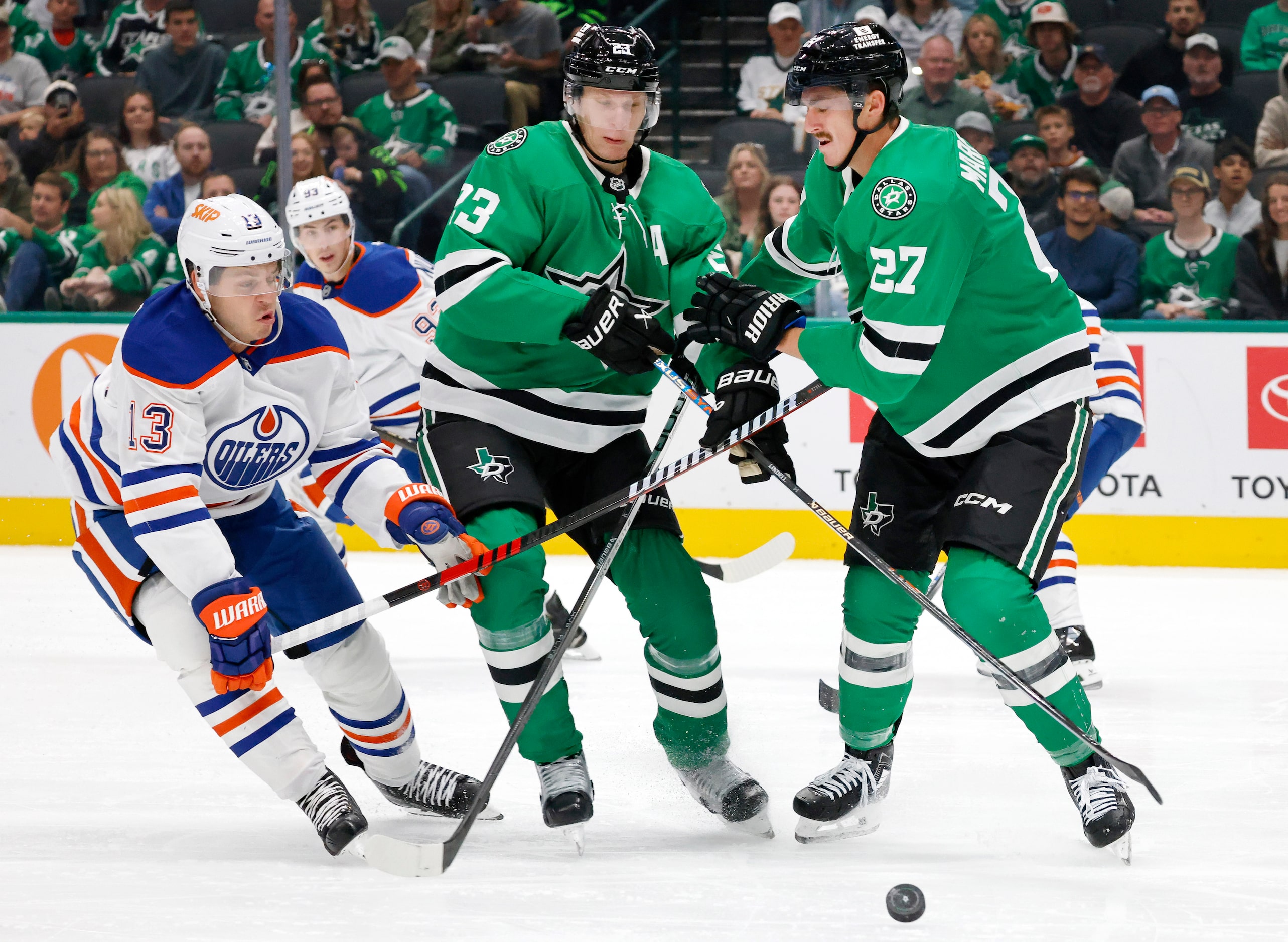 Edmonton Oilers center Mattias Janmark (13), Dallas Stars defenseman Esa Lindell (23) and...