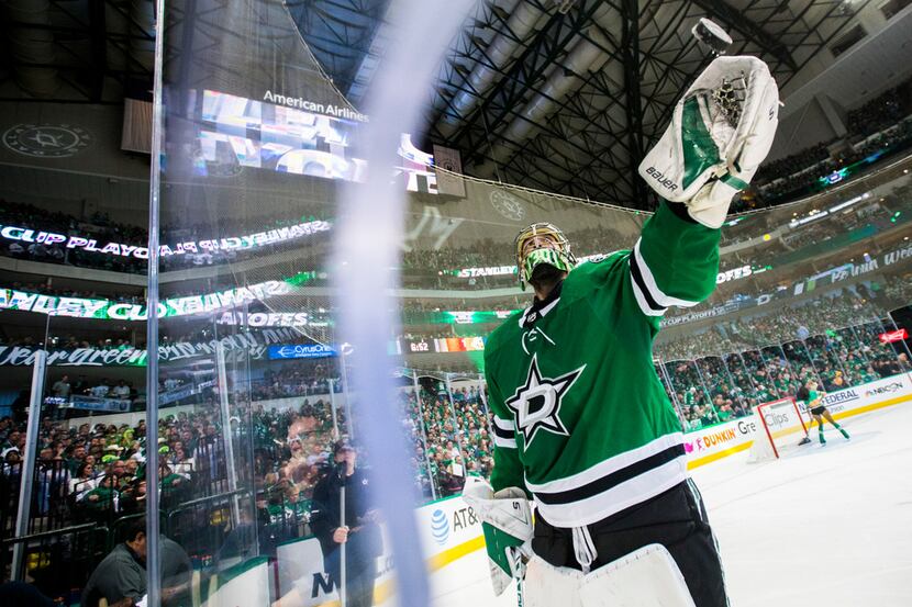 Dallas Stars goaltender Ben Bishop (30) tosses a puck to a fan during the third period of...