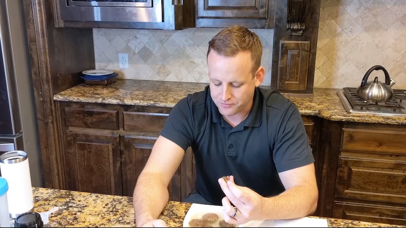 Mitch Felderhoff bites into one of his company's beef meatball dog food products. (Via YouTube)