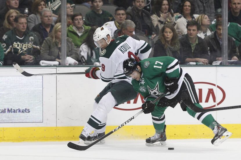 DALLAS, TX - FEBRUARY 08: Mikko Koivu #9 of the Minnesota Wild is pushes off the puck by...