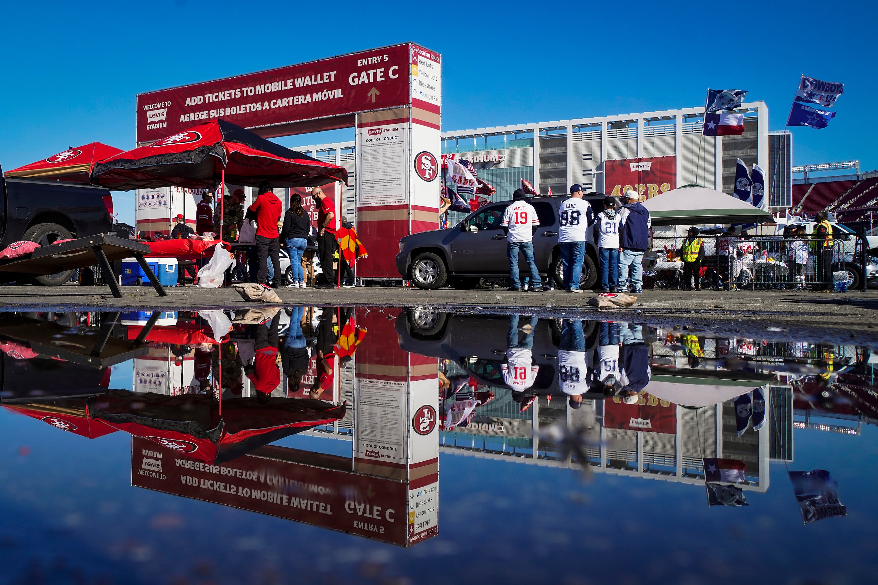 Following weeks of severe weather in Northern California, fans tailgate under clear blue...