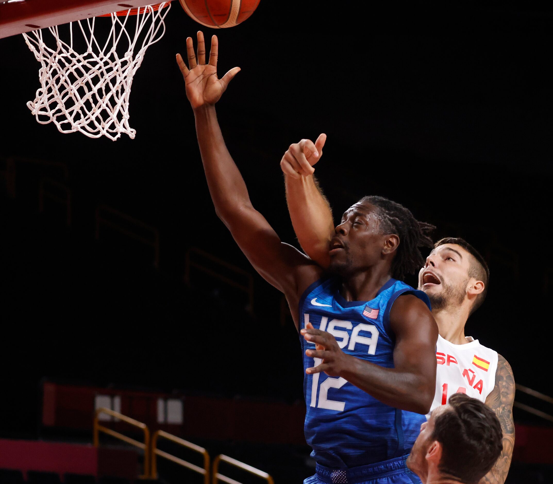 USA’s Jrue Holiday (12) gets his shot blocked by Spain’s Willy Hernangomez (14) during the...