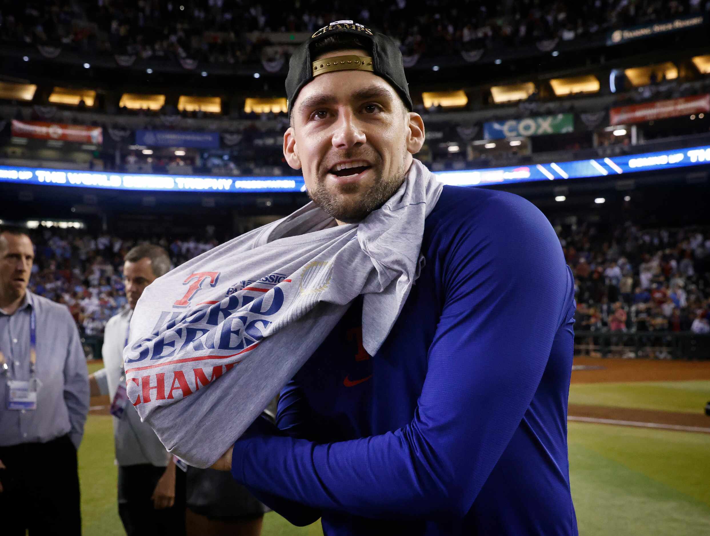 Texas Rangers starting pitcher Nathan Eovaldi puts on his World Series t-shirt as the team...