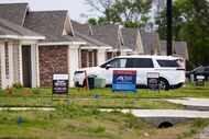 For sale signs in front of a home that are part of a residential development by Dallas...