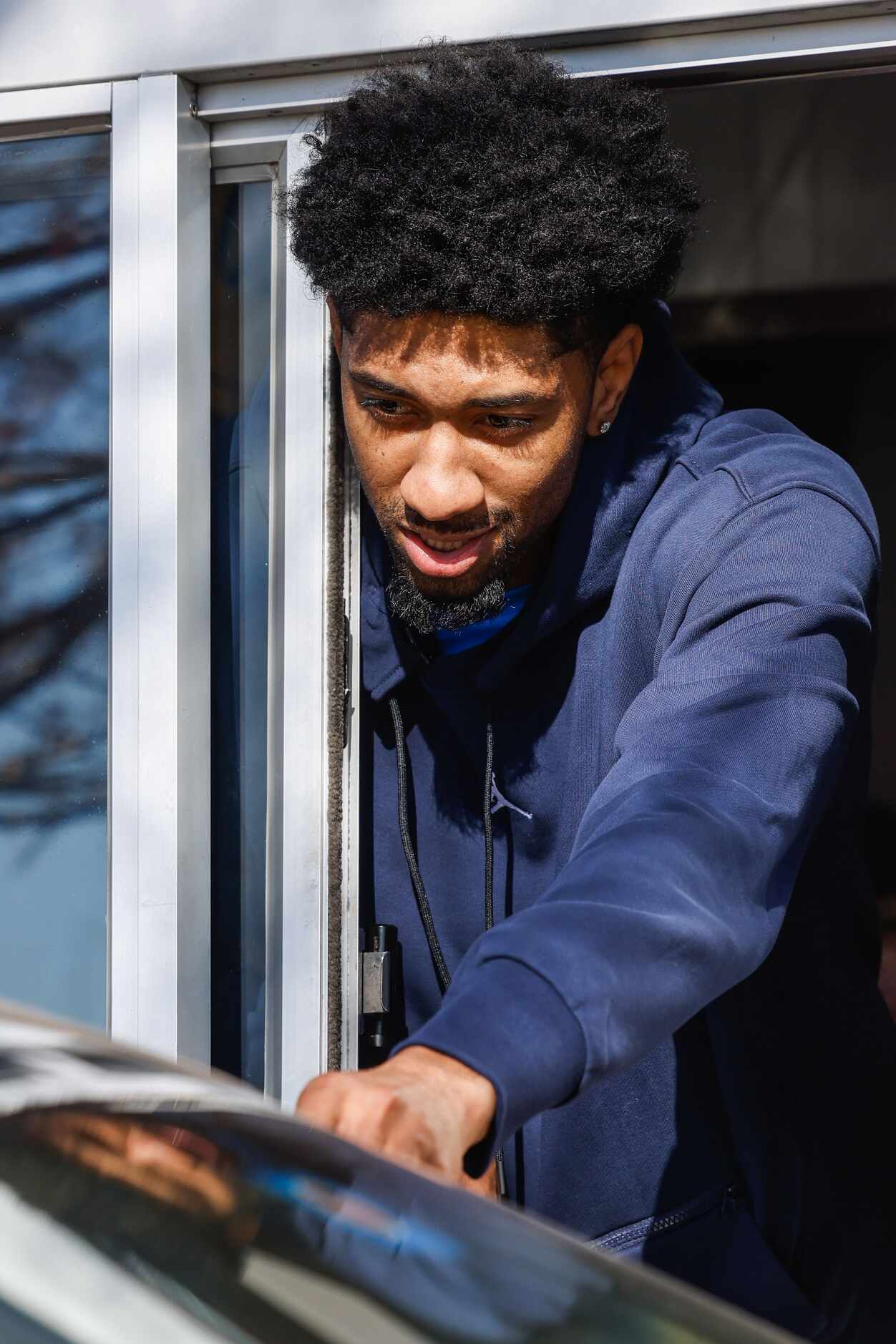 Mavericks player Christian Wood serves lunch at the Raising Cane’s in Dallas on Wednesday,...