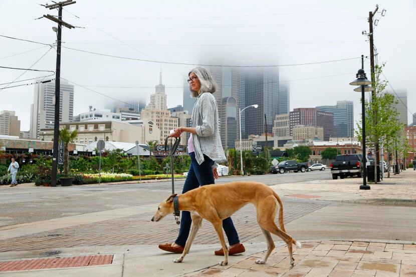 
Tsuki Brooks, a jewelry maker, walks her dog, Aziz, in the Farmers Market neighborhood near...