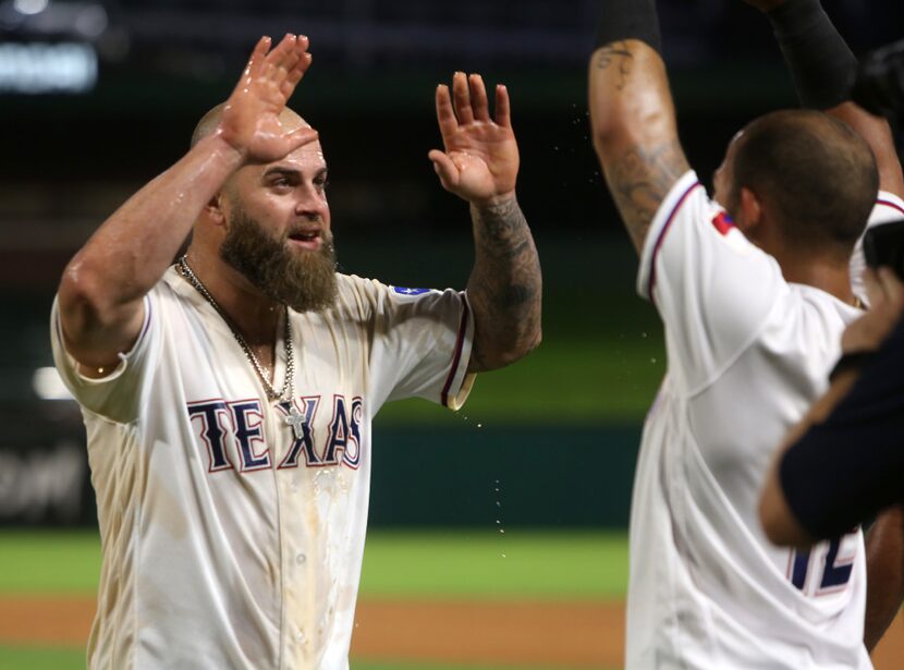 Texas Rangers first baseman Mike Napoli (5) high fives Texas Rangers second baseman Rougned...