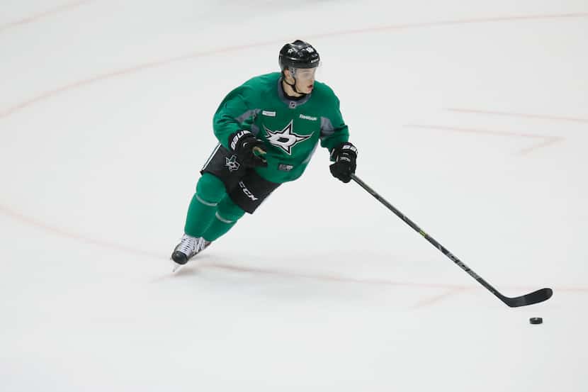 Dallas Stars Julius Honka (#60) controls the puck while he plays in a game during the first...