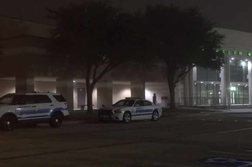 Mesquite police vehicles sit parked outside Poteet High School, near where gunshots were...