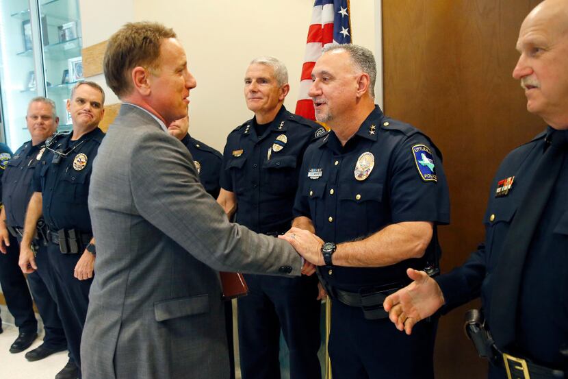 Texas Representative Pat Fallon, Dist. 106 (left) shake hands wth Little Elm police chief...