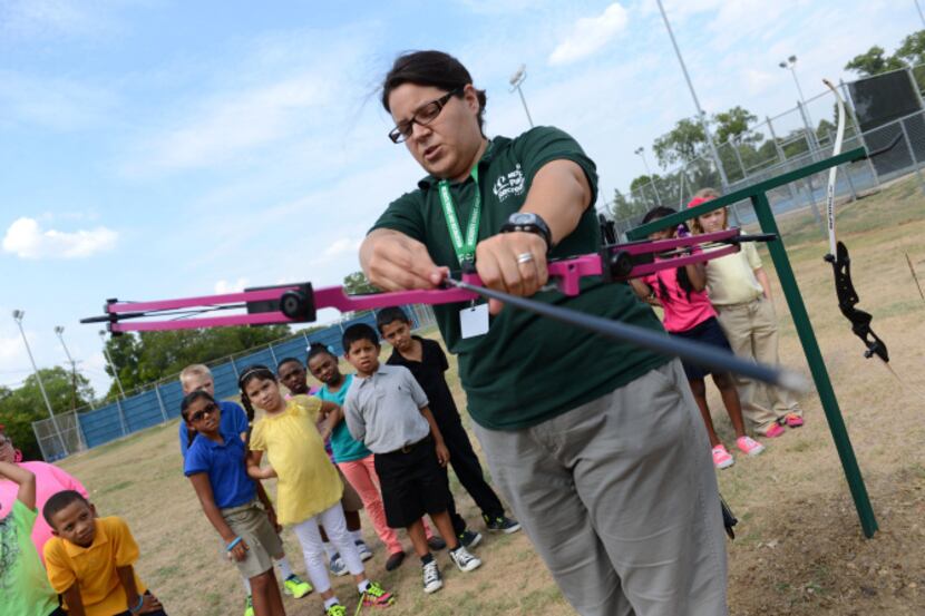 Toni Walton, Mesquite recreation supervisor, gives an archery tutorial to Mesquite ISD...