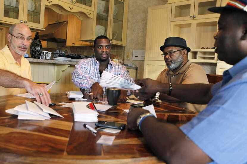 Exoneree and Director of House of Renewed Hope Christopher Scott (second from left) prepared...