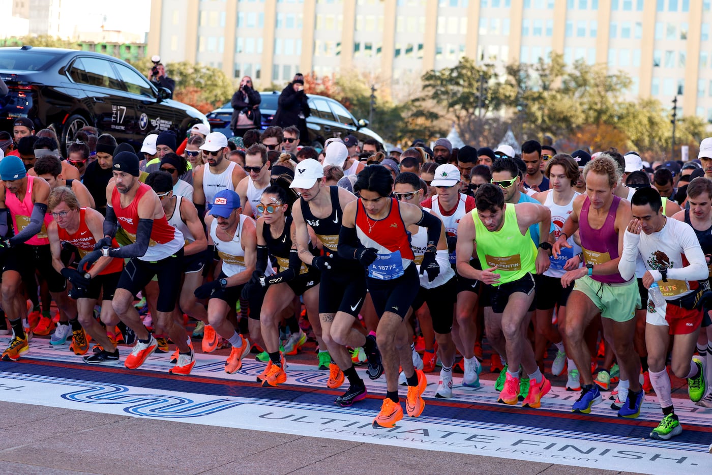 Runners cross the start line in front of Dallas City Hall during 2023 BMW Dallas Marathon...