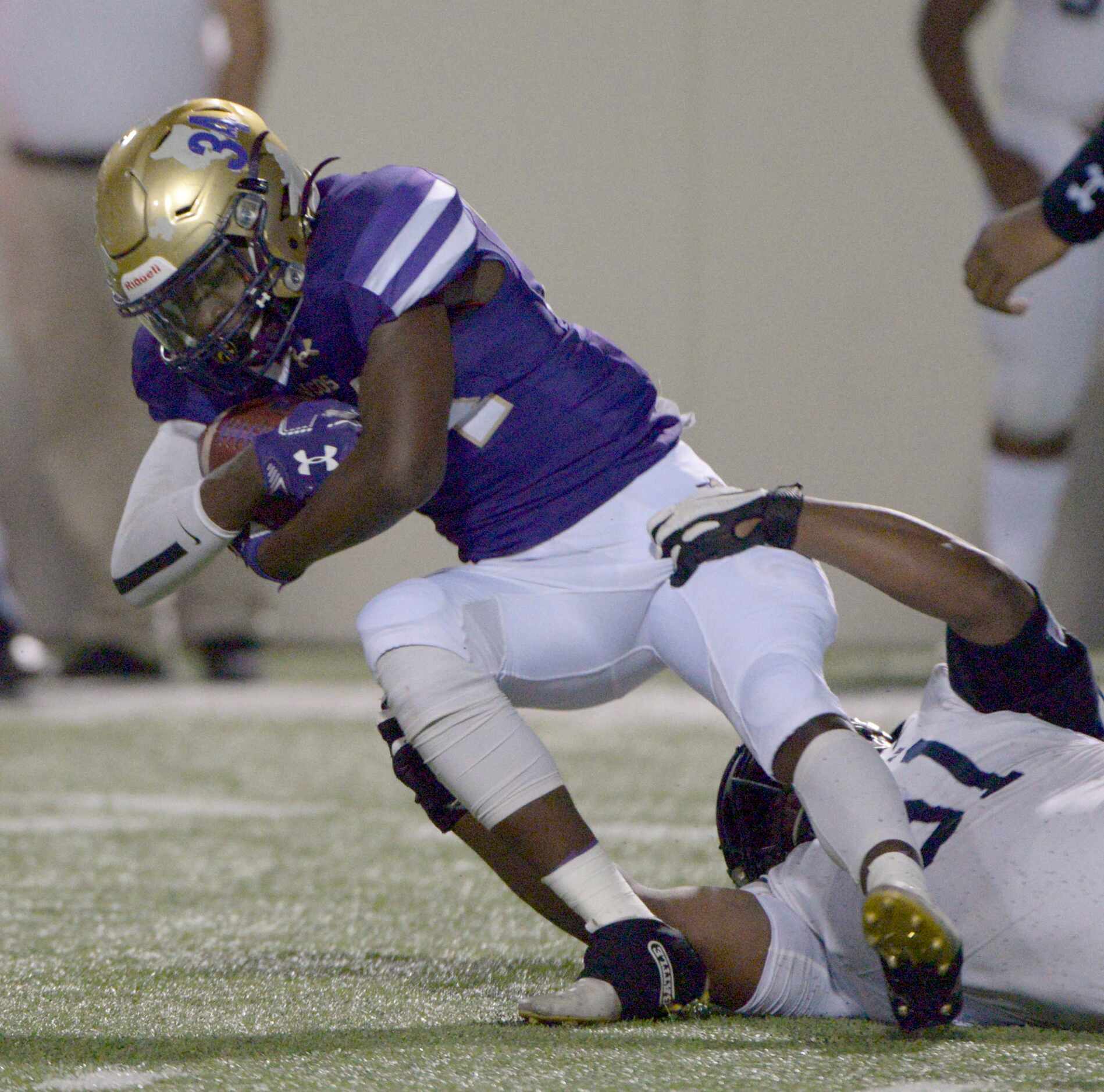 Lone Star’s David Ngegwe (61) tackles Denton’s Coco Brown (34) in the first quarter of a...