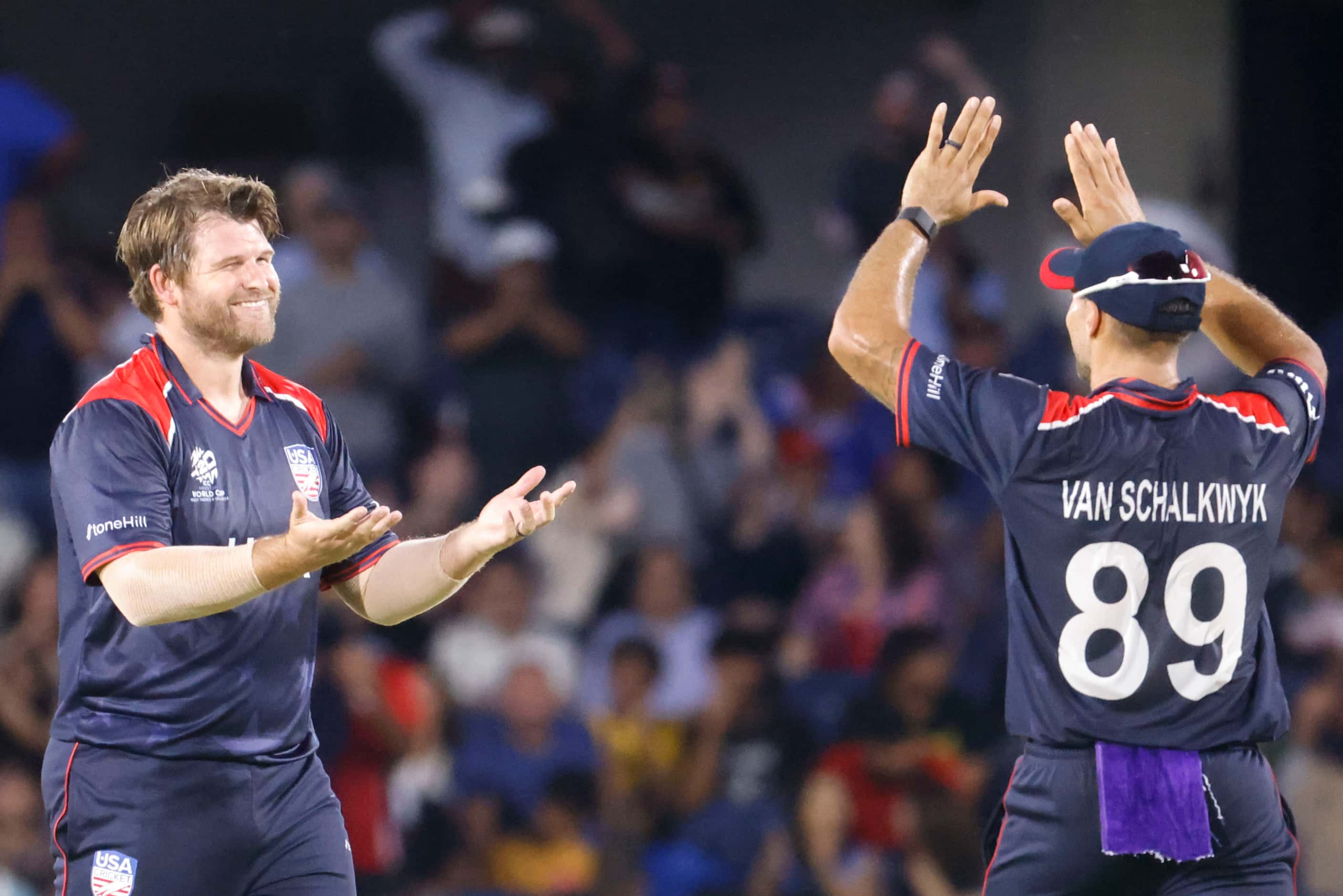 United States' Corey Anderson is congratulated by his team mate Shadley van Schalkwyk during...