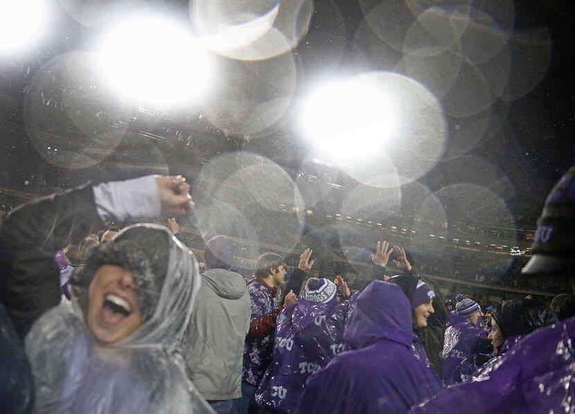 Fans celebrate on the field after TCU's 28-21 win in two overtimes during the Baylor...