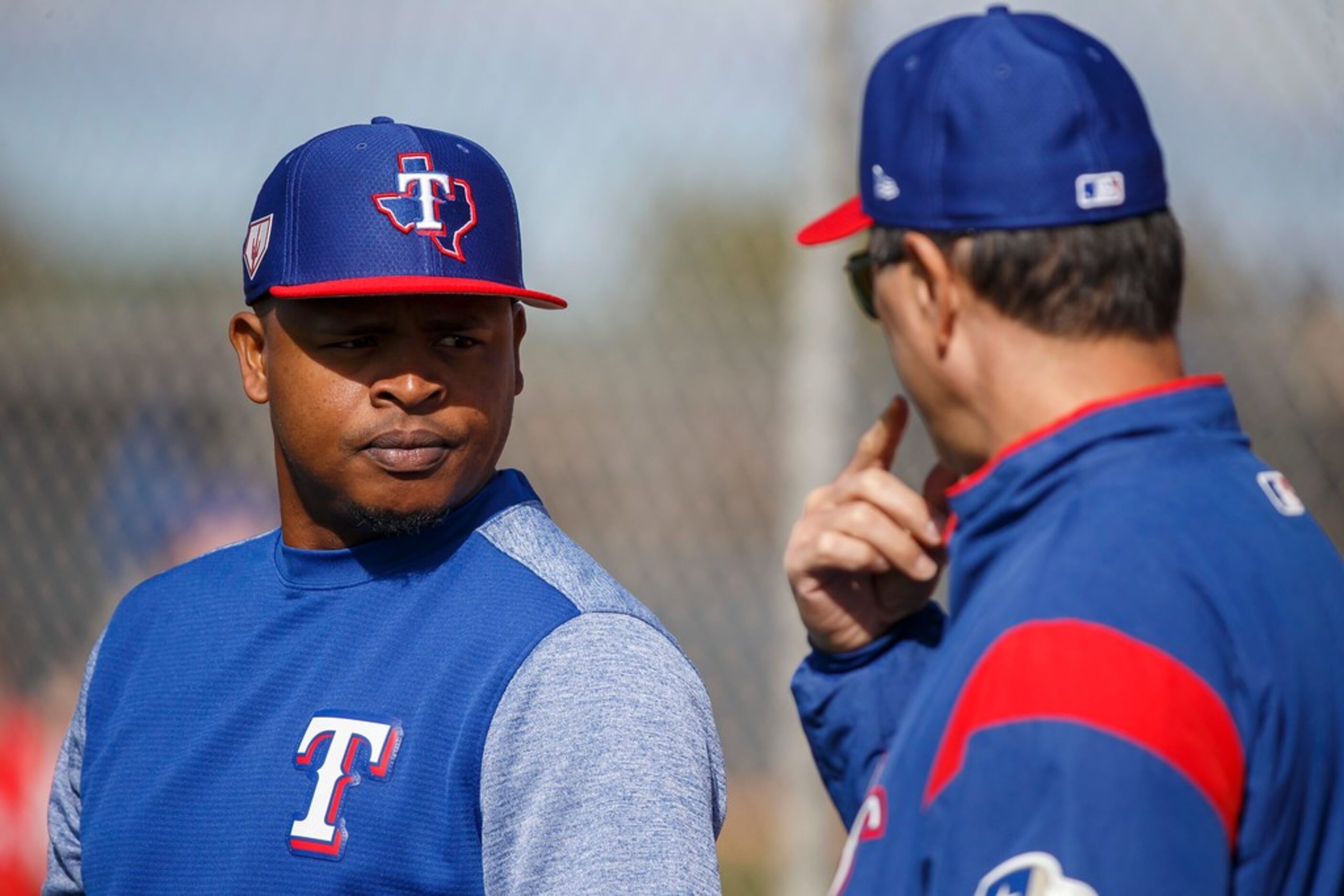 Texas Rangers pitcher Edinson Volquez talks with bench coach Don Wakamatsu during a spring...