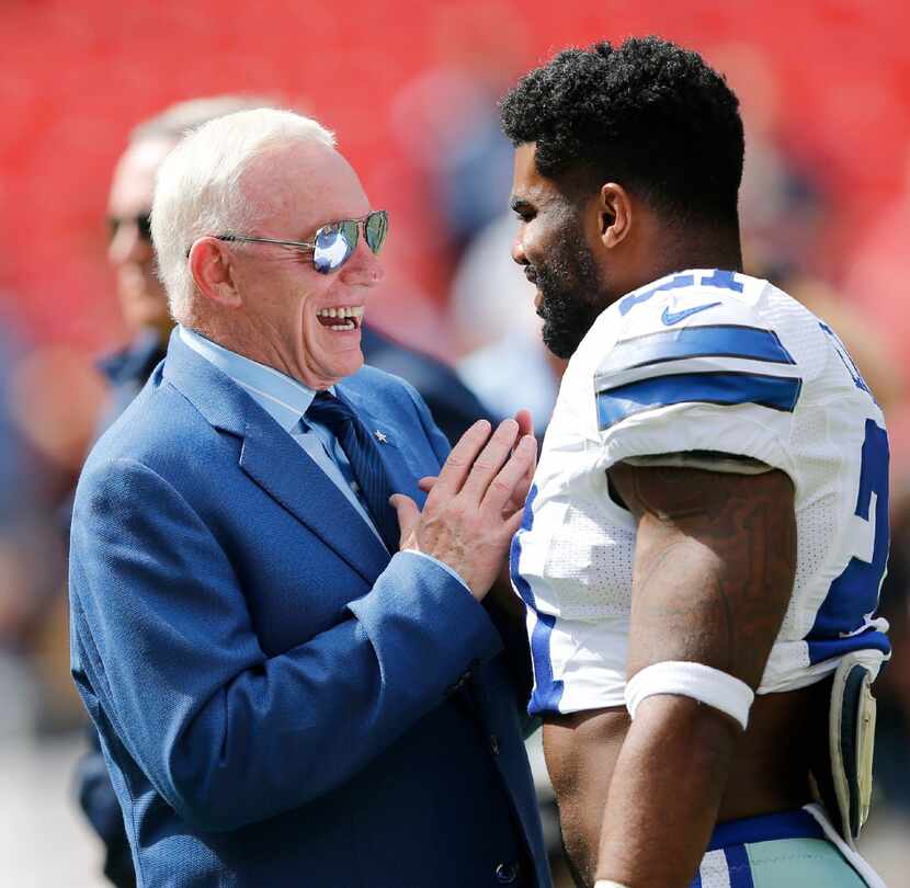Dallas Cowboys owner and general manager Jerry Jones talks with Cowboys running back Ezekiel...