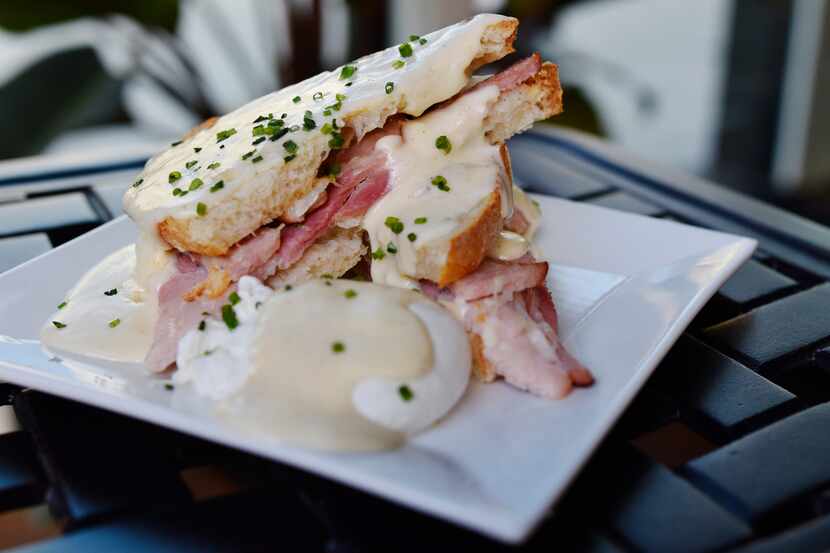 Croque madame, a breakfast sandwich with ham and gruyere on sourdough topped with a béchamel...